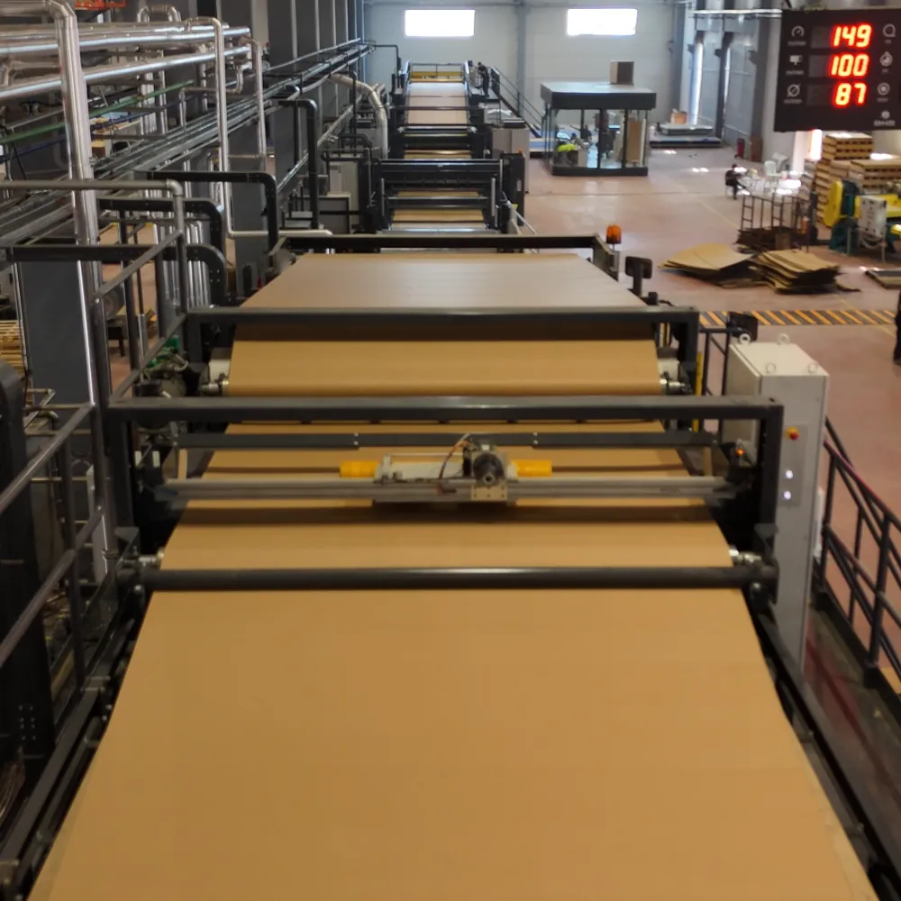 Corrugated board running through a modern corrugator